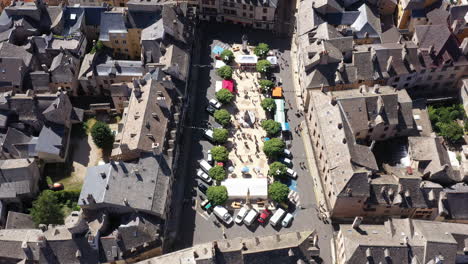 Square-Henri-Cordesse-MArvejols-with-people-and-trees-aerial-top-shot-Aveyron